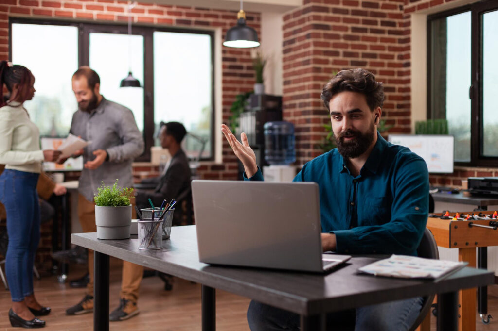 employee doing meeting on a laptop in a coworking space